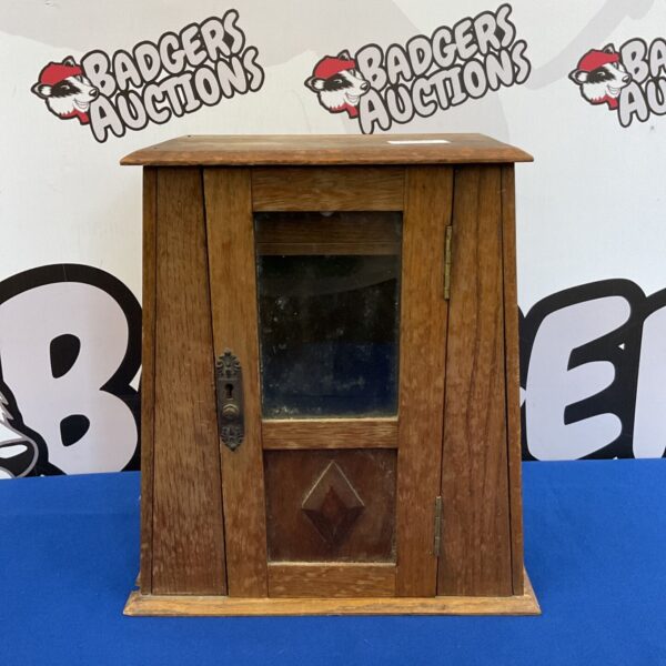 Vintage oak smokers cabinet with glass door and pipe rack.
