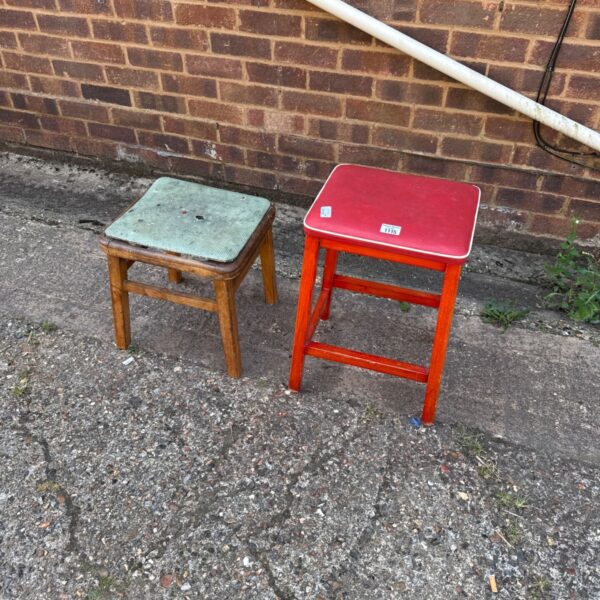 Pair of vintage stools, one red and one green, for rustic decor.