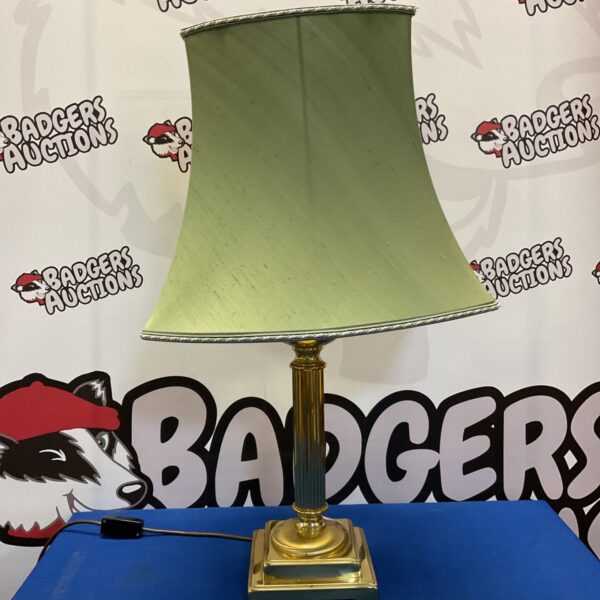 Vintage brass table lamp with cream lampshade for home decor.