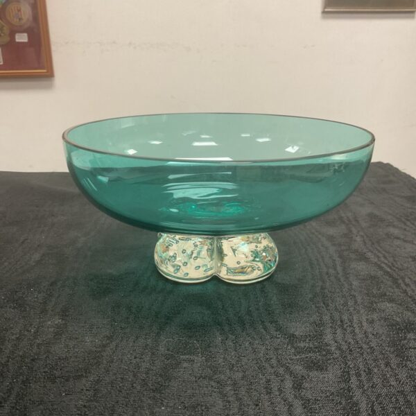 Vintage teal art glass bowl on a dark surface.