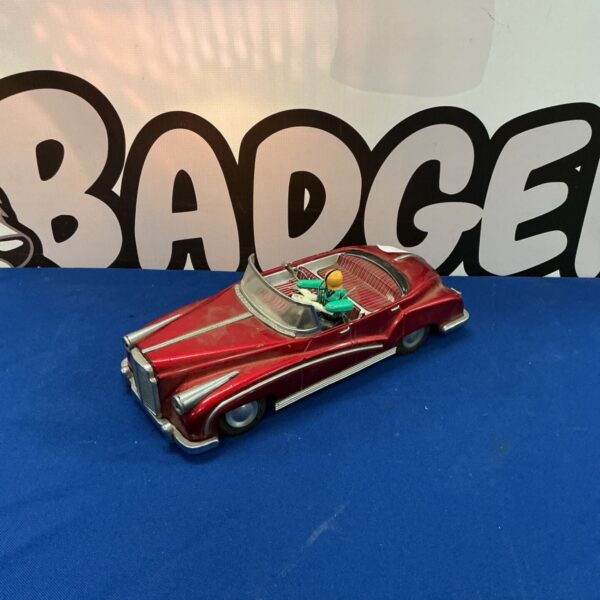 Red vintage tinplate toy car, classic battery operated vehicle.