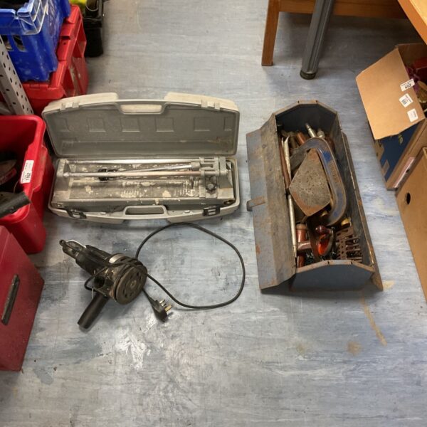 Vintage tool lot including a tile cutter, toolbox, and orbital sander.