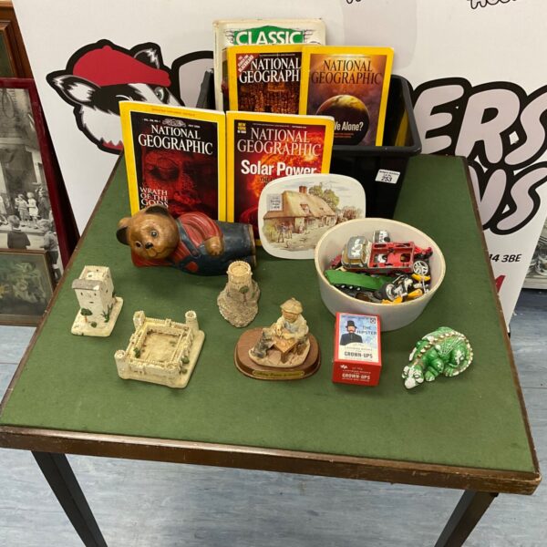 Vintage children’s toys including a wooden teddy bear and Matchbox cars.