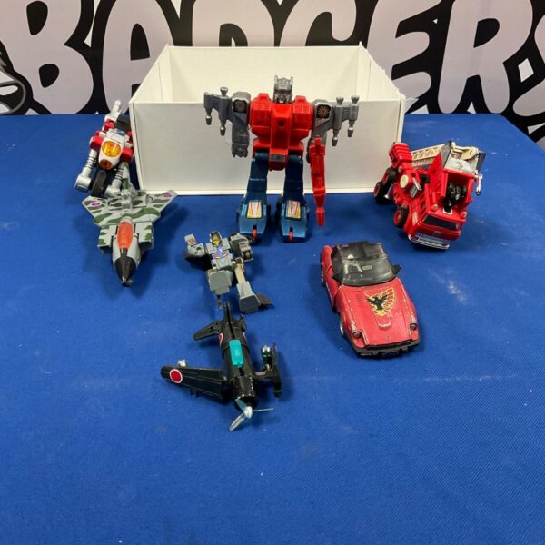 Vintage Transformers toy lot featuring various action figures from the 1980s.