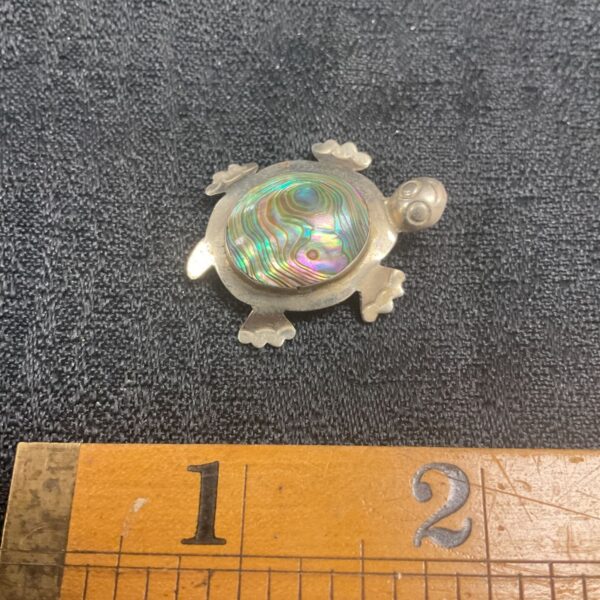 Vintage whitemetal turtle brooch with iridescent shell.