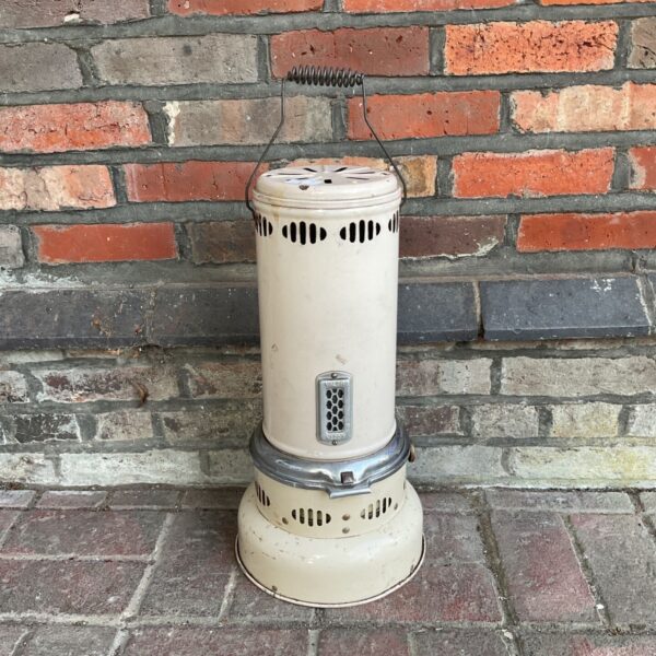 Vintage Valor heater against a brick wall.