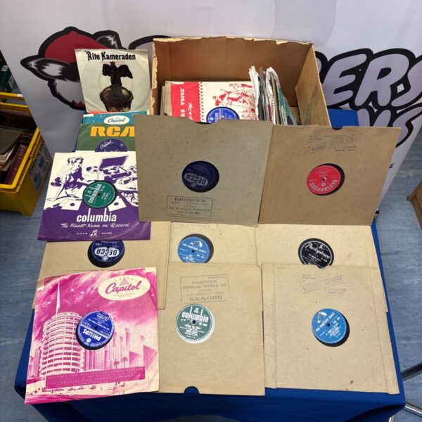 Mixed lot of vintage vinyl records in a cardboard box.