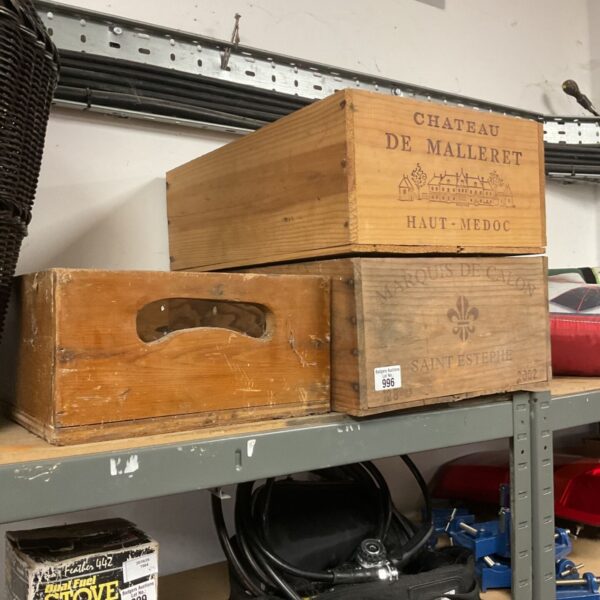 Stacked vintage wine crates with French Chateau branding.