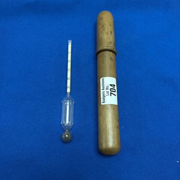 Vintage wine gravity meter with scale in wooden case.