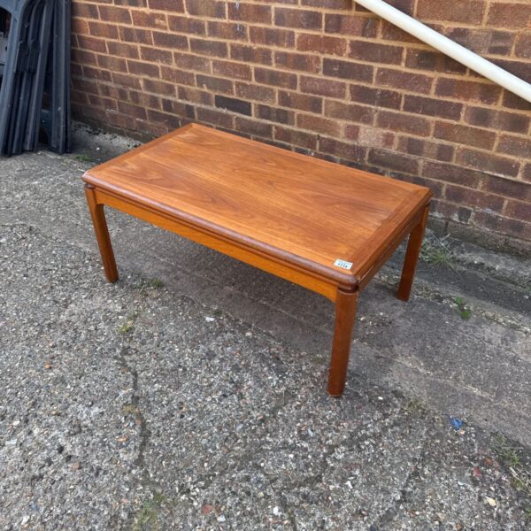 Vintage wooden coffee table with scratches, ideal for restoration project.