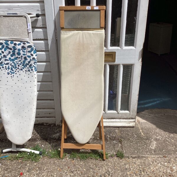 Vintage wooden ironing board with a padded surface, ideal for collectors.