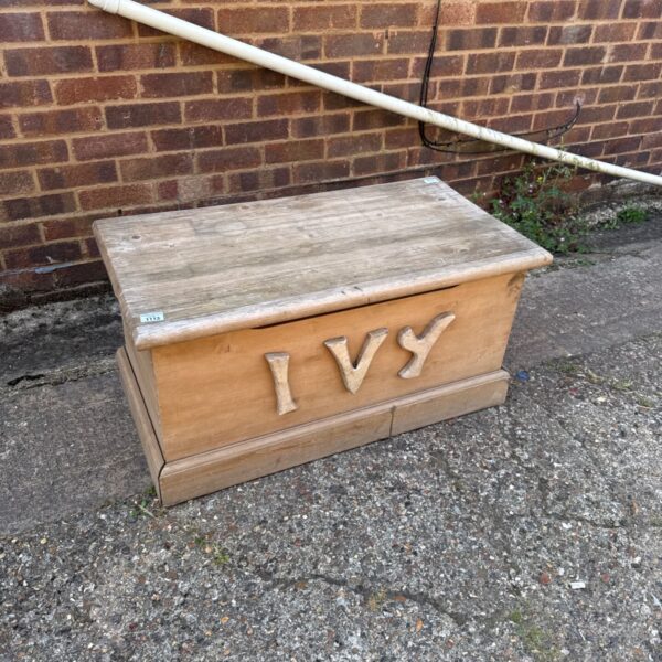 Vintage wooden toy box with "Ivy" lettering, a charming collectible.