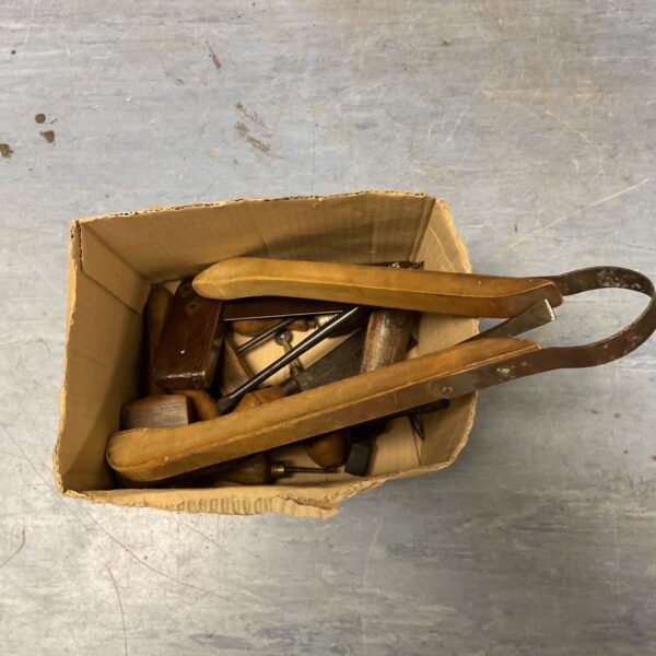 Vintage woodworking tools lot including hand plane and chisels.