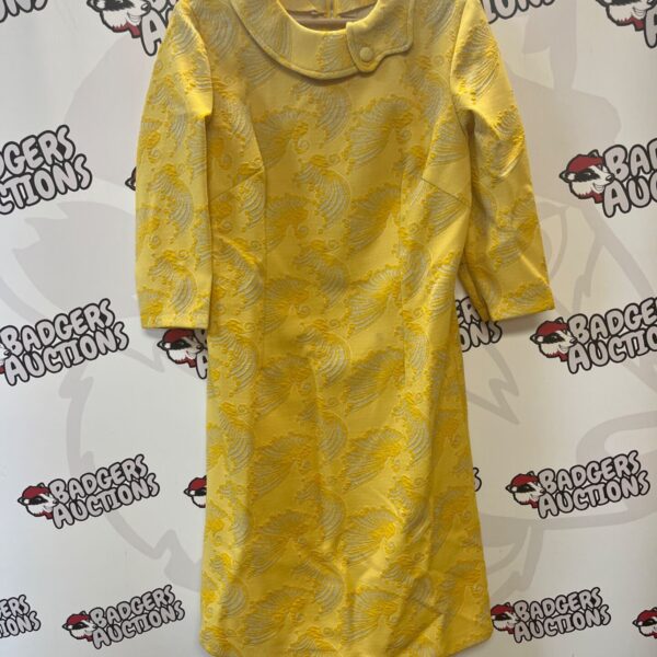 Vintage yellow brocade dress with white floral pattern.