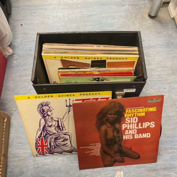 Mixed vinyl record collection in a cardboard case.