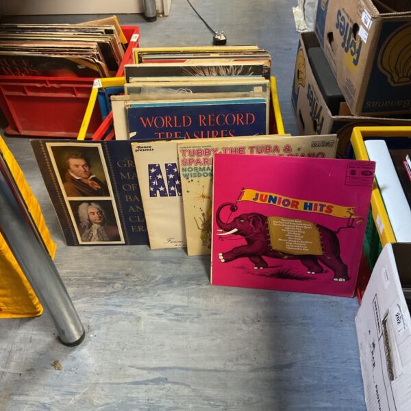 Mixed vinyl record collection with various album covers.