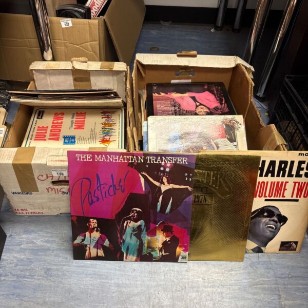 Mixed vinyl record lot in cardboard boxes, vintage music collection.