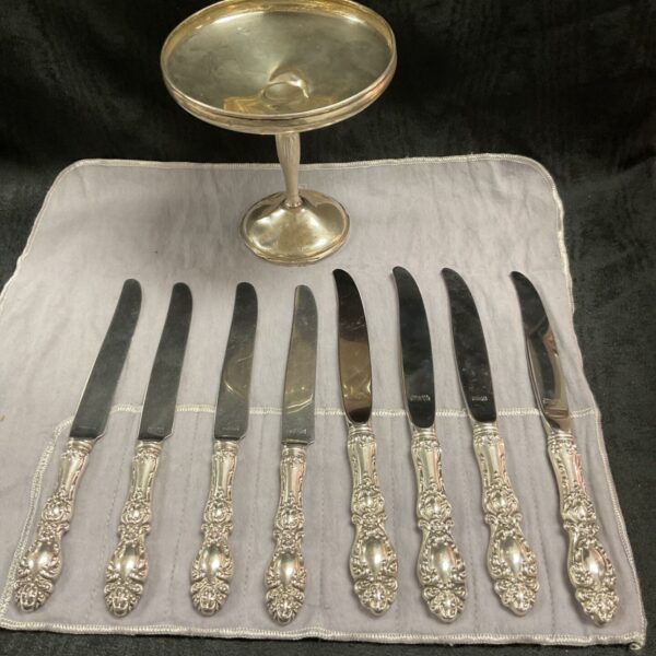 Wallace Lucerne silverware set with knives and pedestal vase.