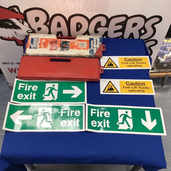 Warning signs including a fire exit and forklift caution triangle.