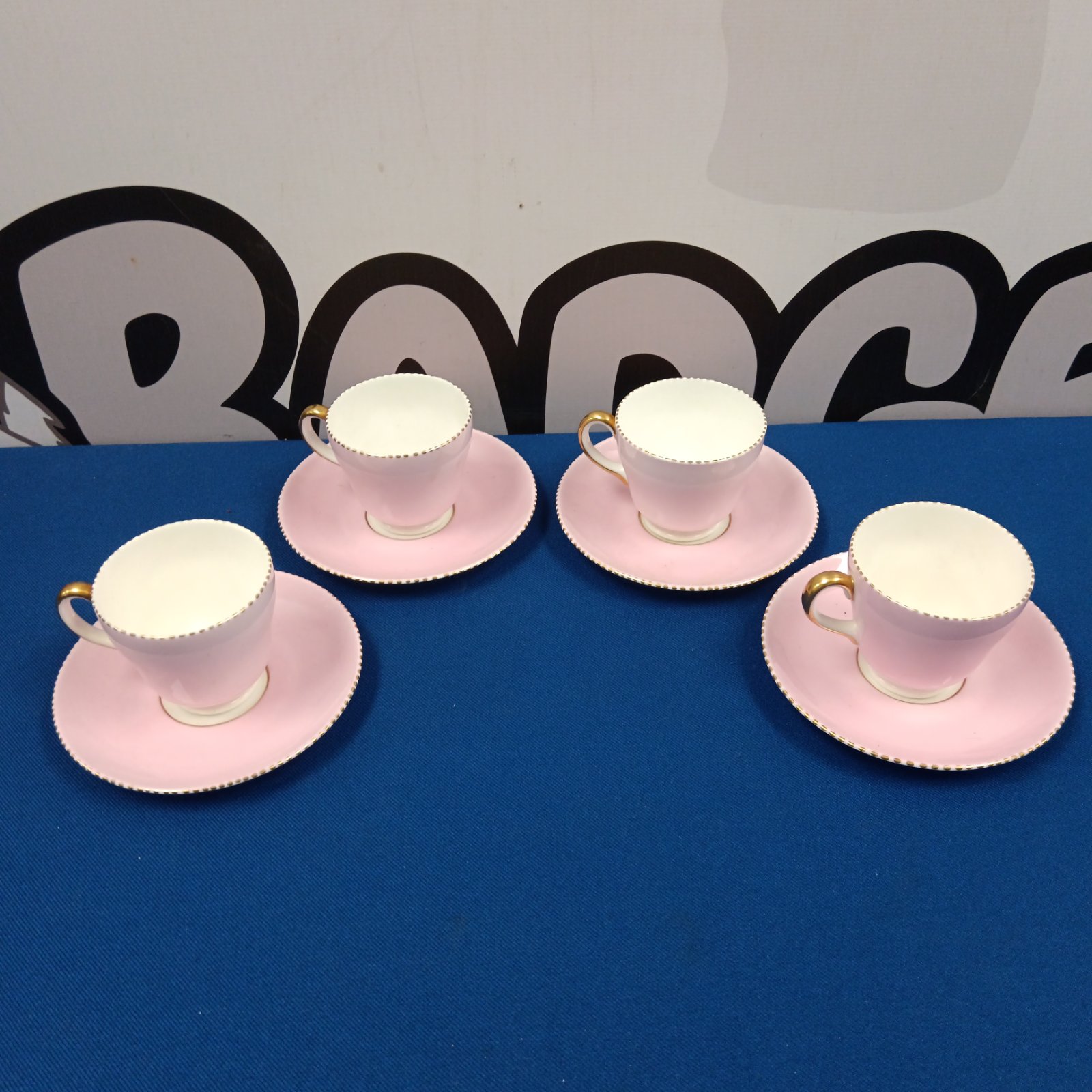 Vintage Wedgwood pink bone china coffee cup set on a pink surface.