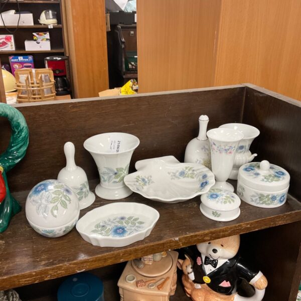 Selection of vintage Wedgwood porcelain trinket boxes with floral designs.