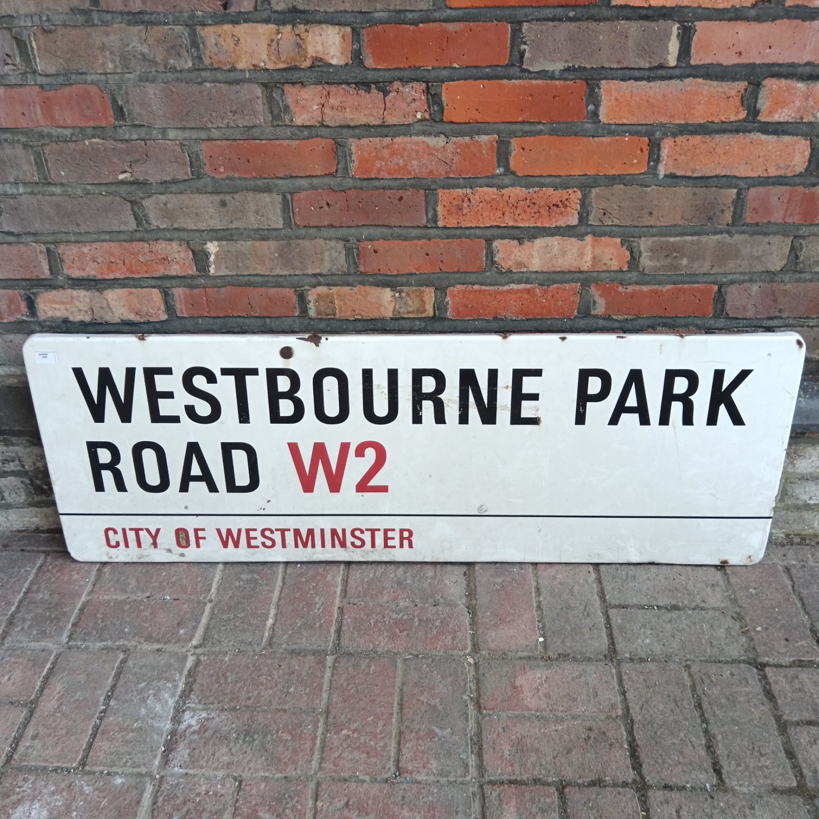 Vintage Westbourne Park Road enamel sign mounted on brick.