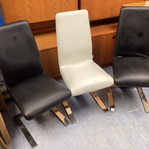 White faux leather dining chair with chrome frame.