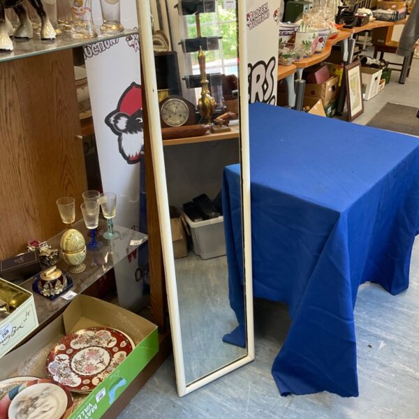 White framed wall mirror measuring 48x12 inches.
