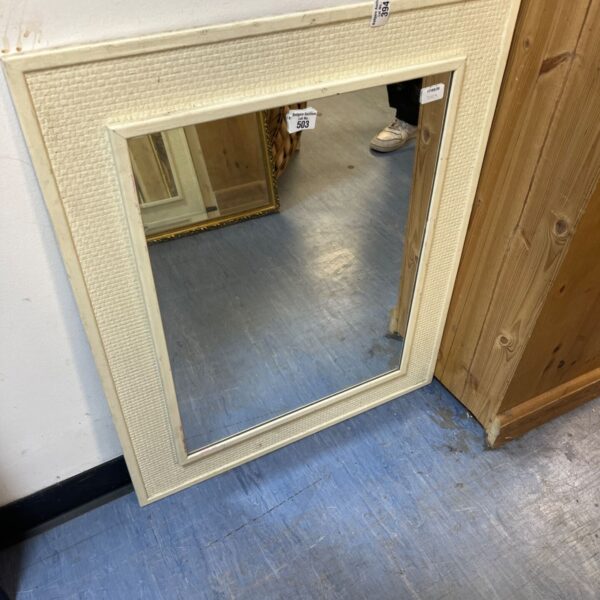 White rattan framed rectangular mirror for wall decoration.