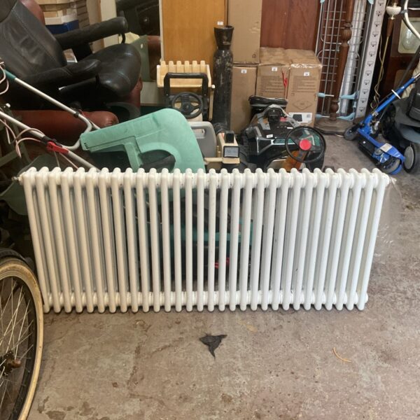 White steel radiator with vertical columns, ideal for vintage home heating.