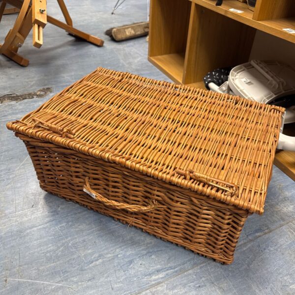 Large wicker hamper basket with lid and handle.