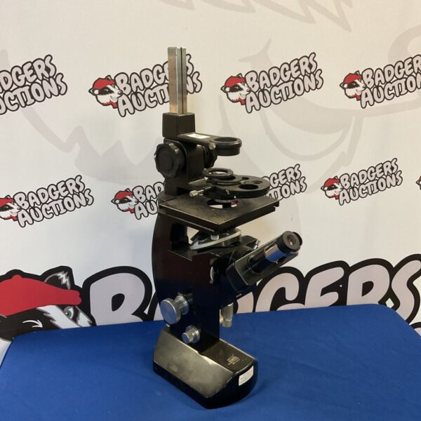Vintage Wild Heerbrugg microscope with adjustable stage and optics.