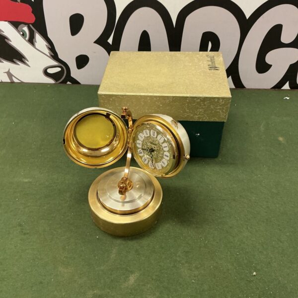 Vintage Windmill globe mantle clock with open cage design.