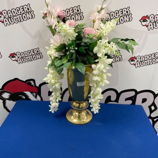 Gold wine bucket with a beautiful artificial flower arrangement.