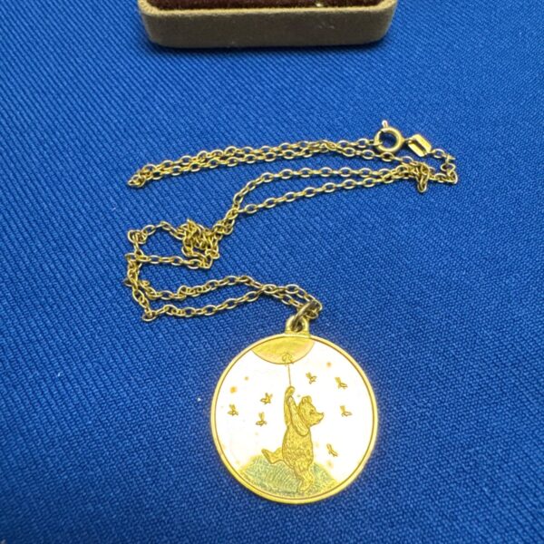Vintage Winnie the Pooh necklace with gold pendant and chain.