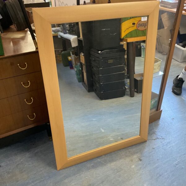 Vintage wood framed wall mirror for home decor.