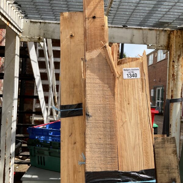 Stack of approximately twelve wood planks for DIY projects.