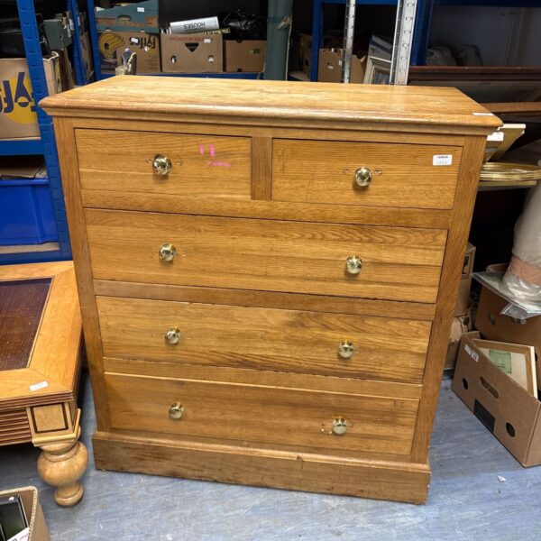 Vintage wooden chest of drawers with five drawers, ideal for bedroom storage.