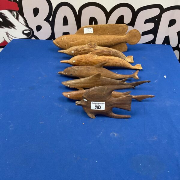 Lot of seven carved wooden fish ornaments for home decor.