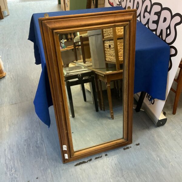 Vintage wooden framed mirror for wall decoration.
