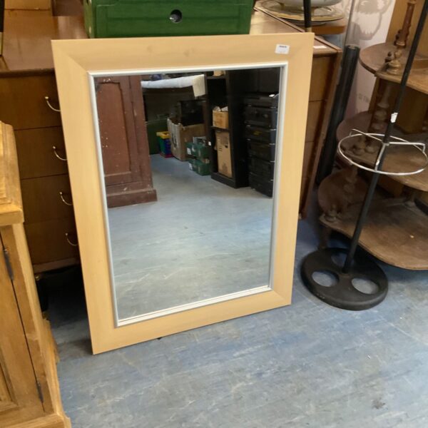 Vintage wooden framed wall mirror for home decor.