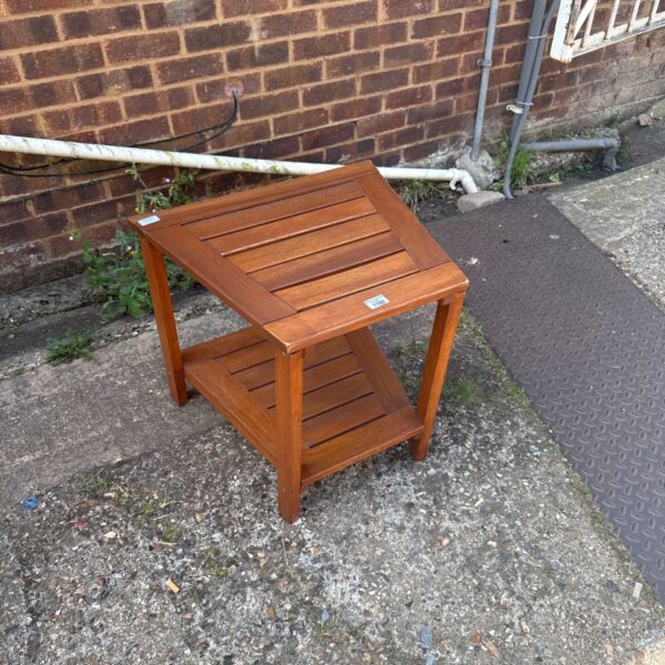 Rustic wooden slat side table for garden or patio use.