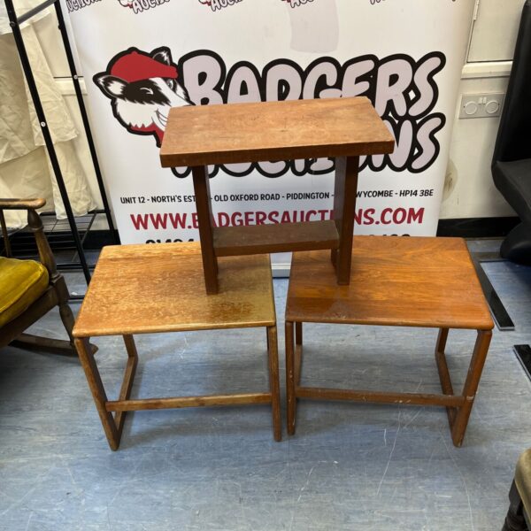 Lot of three vintage wooden side tables with a rustic aesthetic.