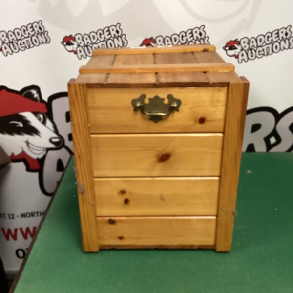 Small wooden storage box with three drawers for organization.