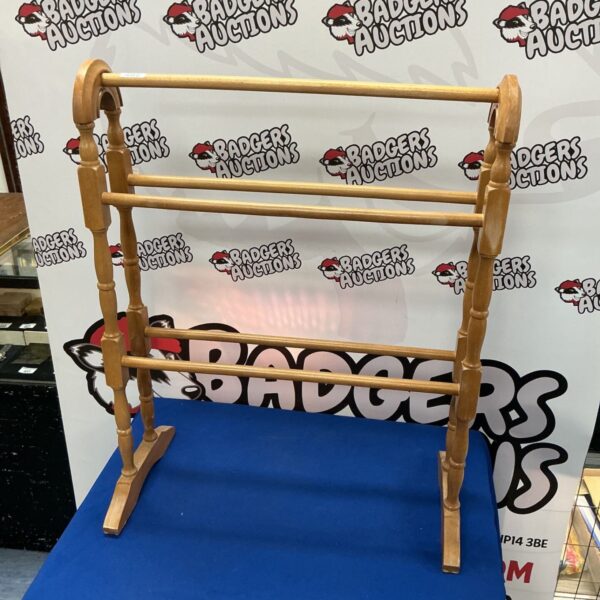 Vintage wooden towel rack for bathroom storage.