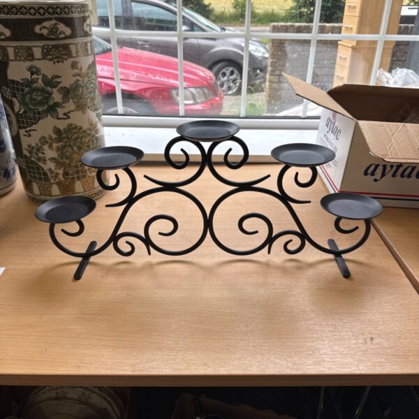Vintage wrought iron candelabra with three candle holders.