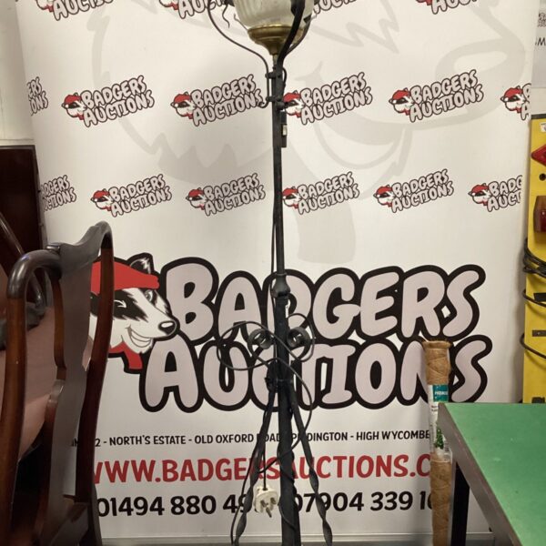 Vintage wrought iron floor lamp with decorative shade holder.