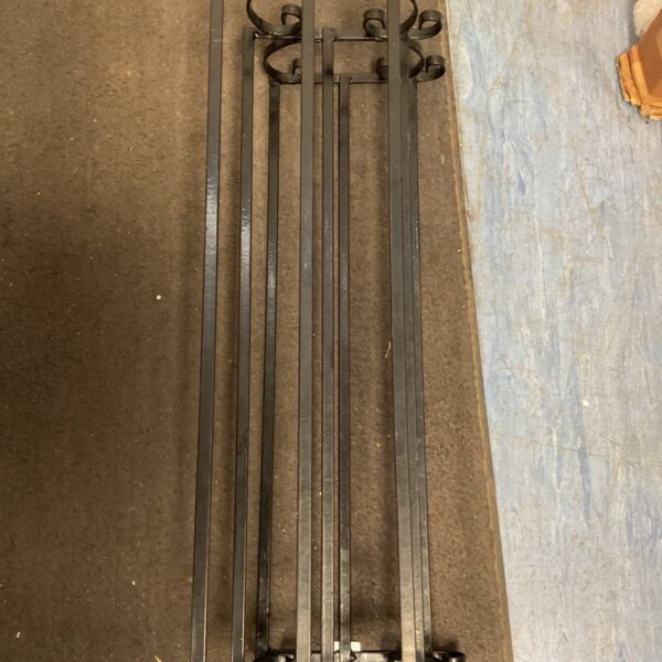 Set of four vintage wrought iron wall brackets with scrolling details.