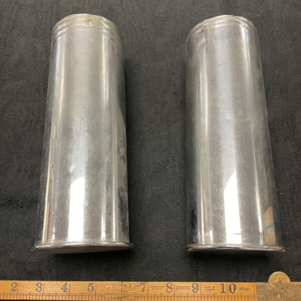 Pair of WWI German cannon shells showing wear and markings.