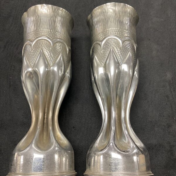 Pair of antique WWI British trench art shells with embossed detailing.